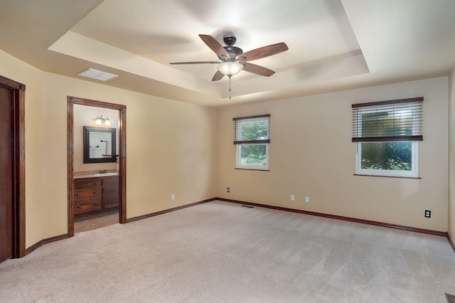14521 Lawrence Unit 2145, Mount Vernon, MO 65712 - spare room with a tray ceiling, light carpet, and a ceiling fan