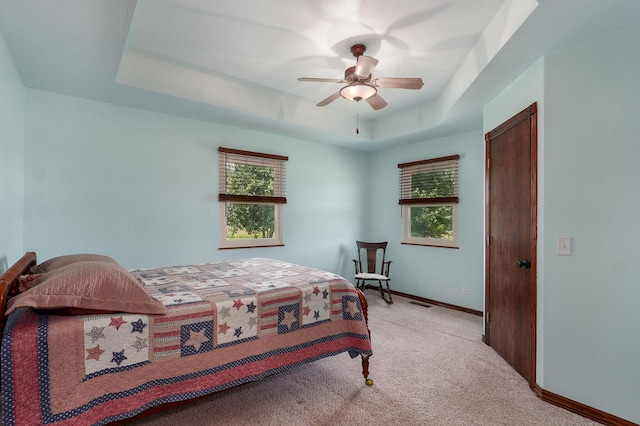 14521 Lawrence Unit 2145, Mount Vernon, MO 65712 - bedroom with a raised ceiling, multiple windows, carpet, and a ceiling fan