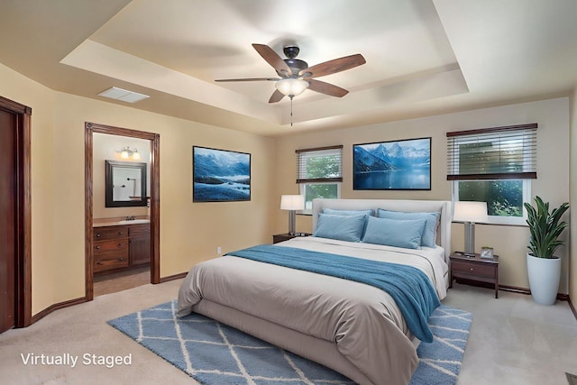 14521 Lawrence Unit 2145, Mount Vernon, MO 65712 - bedroom featuring a tray ceiling, light colored carpet, ensuite bath, and a ceiling fan