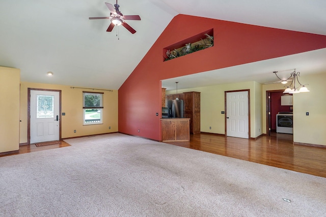 14521 Lawrence Unit 2145, Mount Vernon, MO 65712 - unfurnished living room featuring washer / dryer, carpet, ceiling fan, and high vaulted ceiling