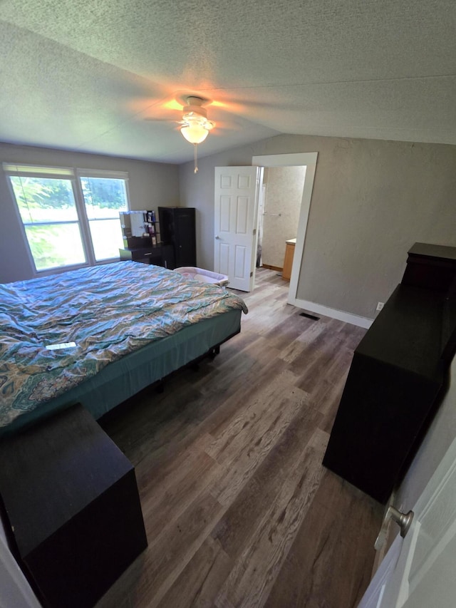 4662 S 30th Rd, Fair Play, MO 65649 - bedroom with lofted ceiling, wood finished floors, a textured ceiling, and ceiling fan