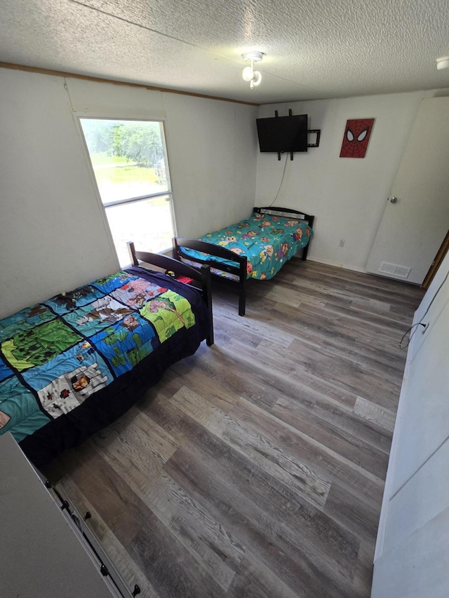 4662 S 30th Rd, Fair Play, MO 65649 - bedroom featuring wood finished floors and a textured ceiling