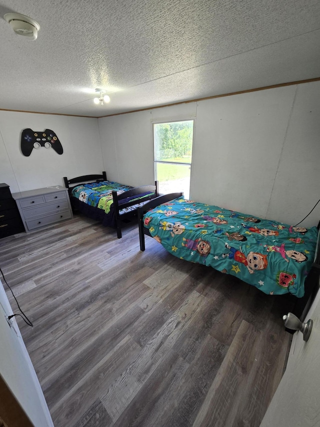 4662 S 30th Rd, Fair Play, MO 65649 - bedroom with wood finished floors and a textured ceiling