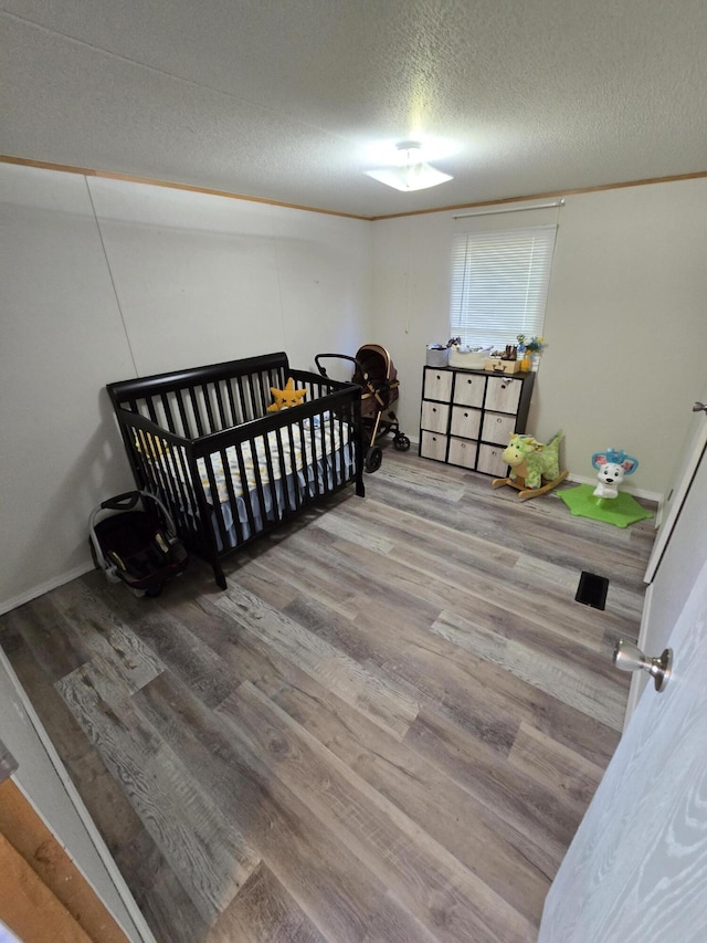 4662 S 30th Rd, Fair Play, MO 65649 - bedroom with a textured ceiling and wood finished floors