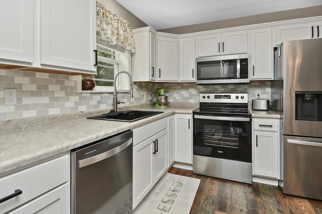 237 Kelsi Ln, Branson, MO 65616 - kitchen with stainless steel appliances, white cabinetry, light countertops, and backsplash