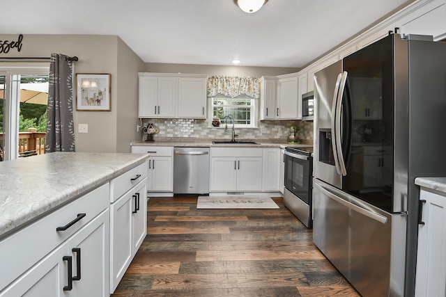 237 Kelsi Ln, Branson, MO 65616 - kitchen featuring appliances with stainless steel finishes, dark wood-type flooring, tasteful backsplash, light countertops, and white cabinets