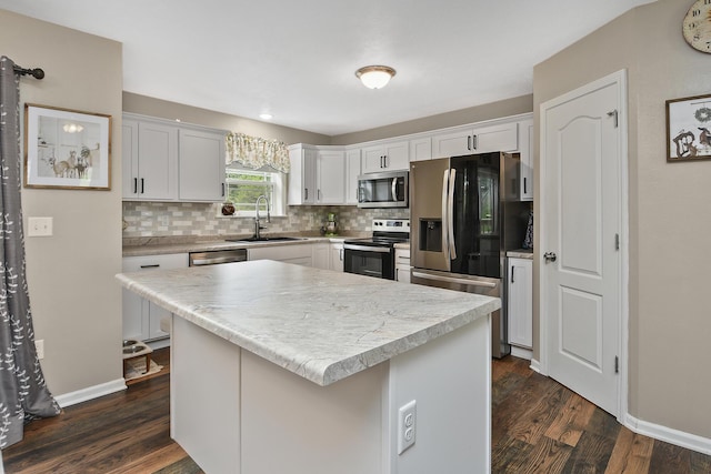 237 Kelsi Ln, Branson, MO 65616 - kitchen featuring appliances with stainless steel finishes, decorative backsplash, dark wood finished floors, and light countertops