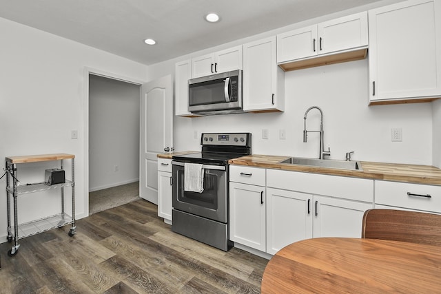 237 Kelsi Ln, Branson, MO 65616 - kitchen featuring stainless steel appliances, wood counters, dark wood-style floors, white cabinetry, and recessed lighting