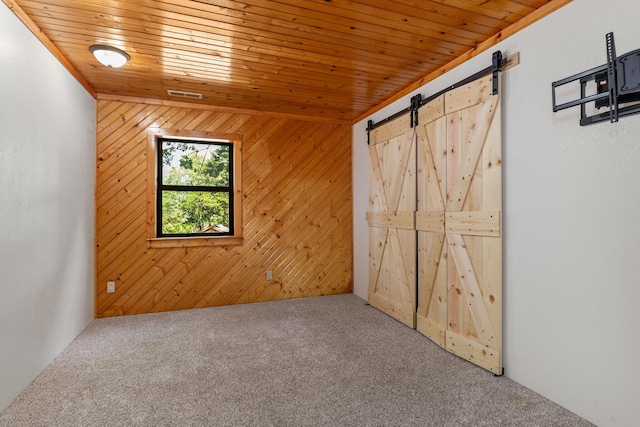 537 Watson Rd, Branson, MO 65616 - unfurnished bedroom featuring carpet flooring, a barn door, wooden walls, and wooden ceiling
