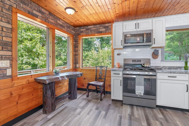 537 Watson Rd, Branson, MO 65616 - kitchen with appliances with stainless steel finishes, white cabinetry, wooden ceiling, light wood finished floors, and light stone countertops