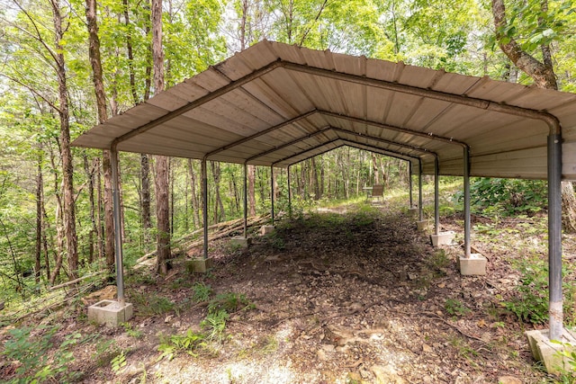 537 Watson Rd, Branson, MO 65616 - view of parking / parking lot with a carport and a wooded view