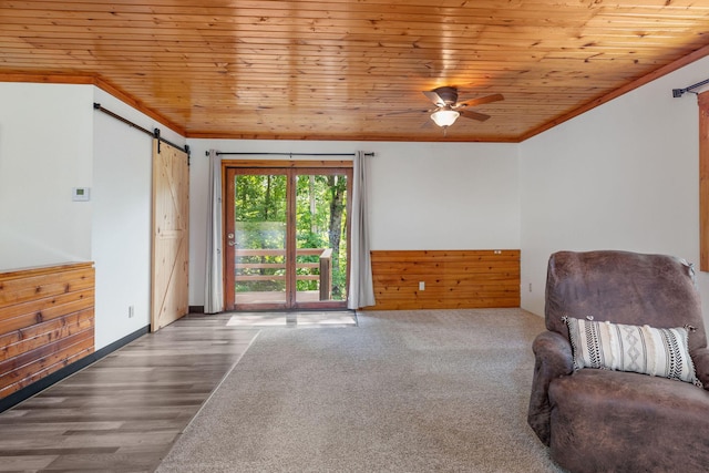 537 Watson Rd, Branson, MO 65616 - living area with a barn door, ornamental molding, wooden ceiling, ceiling fan, and a wainscoted wall