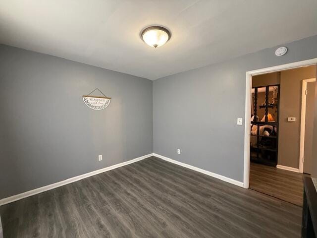 212 W Lindberg St, Springfield, MO 65807 - empty room with dark wood finished floors and a smoke detector