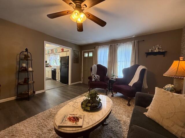 212 W Lindberg St, Springfield, MO 65807 - living room with dark wood finished floors and a ceiling fan