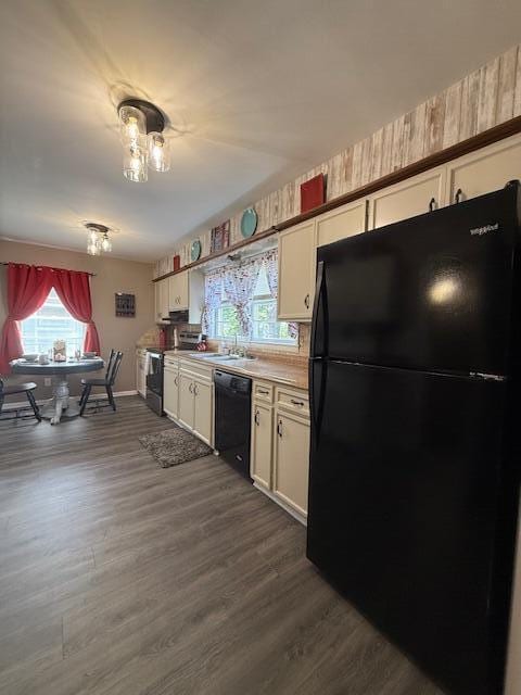 212 W Lindberg St, Springfield, MO 65807 - kitchen with black appliances, healthy amount of natural light, white cabinetry, and dark wood-style floors