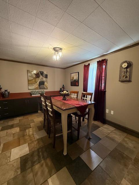 212 W Lindberg St, Springfield, MO 65807 - dining area featuring crown molding and baseboards