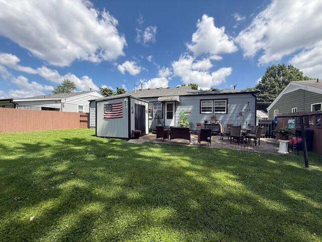 212 W Lindberg St, Springfield, MO 65807 - back of house with a shed and a patio area