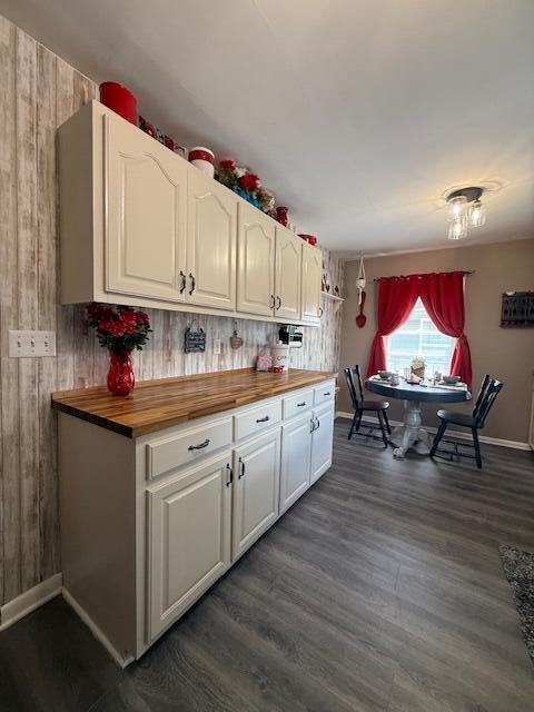 212 W Lindberg St, Springfield, MO 65807 - kitchen with wood counters, white cabinetry, dark wood-style floors, and wooden walls