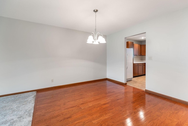 6 Maple Ct, Branson, MO 65616 - unfurnished room with a chandelier and light wood-style flooring