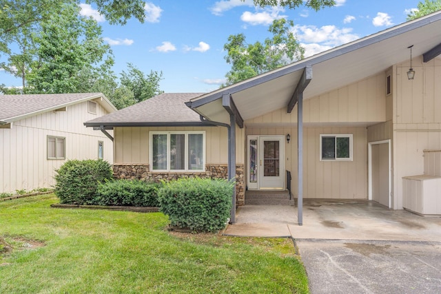 6 Maple Ct, Branson, MO 65616 - view of front of home with a front yard, a shingled roof, an attached carport, driveway, and stone siding