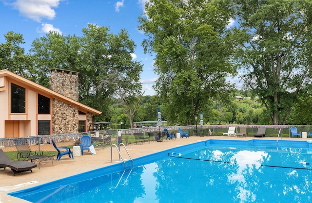 6 Maple Ct, Branson, MO 65616 - community pool with a patio and view of wooded area