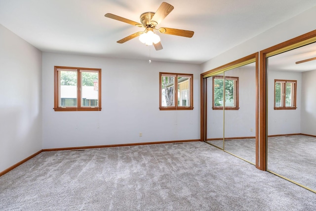 6 Maple Ct, Branson, MO 65616 - unfurnished bedroom with carpet flooring, multiple windows, two closets, and ceiling fan
