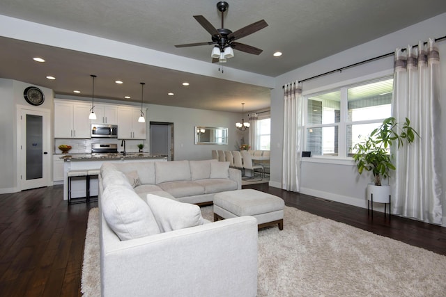 677 N Fox Hill Cir, Nixa, MO 65714 - living room featuring dark wood-type flooring, a chandelier, recessed lighting, and a ceiling fan