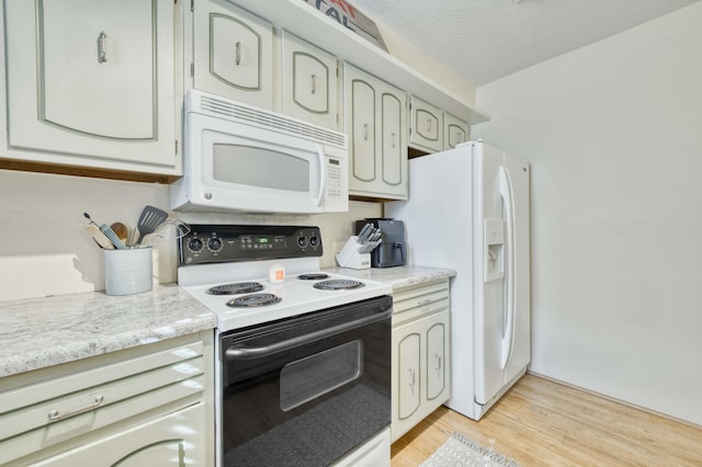 4 Port Holiday Dr Unit C, Kimberling City, MO 65686 - kitchen featuring white appliances, light countertops, light wood finished floors, and a textured ceiling