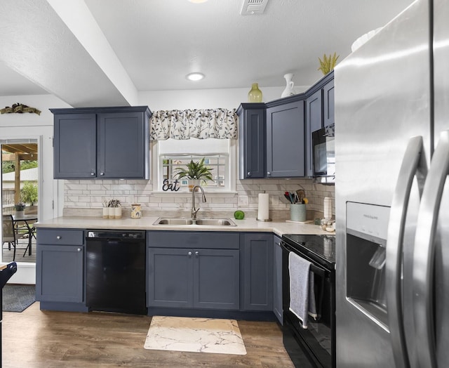 135 Pin Oak Ct, Hollister, MO 65672 - kitchen featuring black appliances, light countertops, tasteful backsplash, and dark wood-style flooring