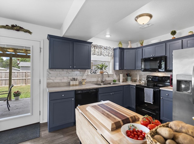 135 Pin Oak Ct, Hollister, MO 65672 - kitchen with black appliances, light countertops, decorative backsplash, dark wood finished floors, and recessed lighting