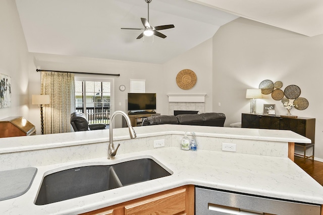 1376 N Sandy Creek Cir # 1, Nixa, MO 65714 - kitchen featuring vaulted ceiling, a ceiling fan, open floor plan, a tile fireplace, and wood finished floors