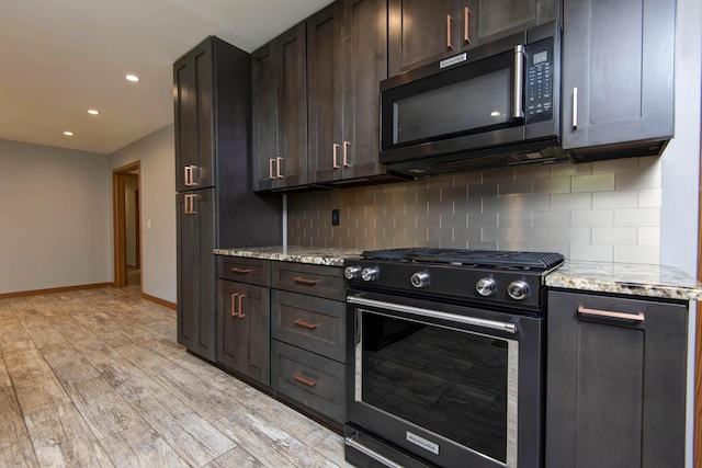 2210 S Catalina Ave, Springfield, MO 65804 - kitchen featuring stainless steel appliances, decorative backsplash, recessed lighting, light stone counters, and light wood finished floors