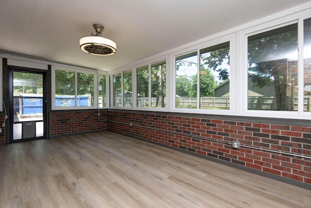 2210 S Catalina Ave, Springfield, MO 65804 - unfurnished sunroom featuring brick wall and wood finished floors