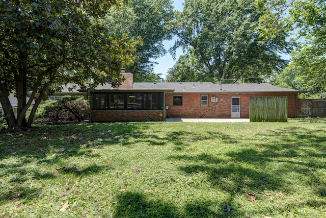 2210 S Catalina Ave, Springfield, MO 65804 - back of house with a sunroom, brick siding, a chimney, and a patio area