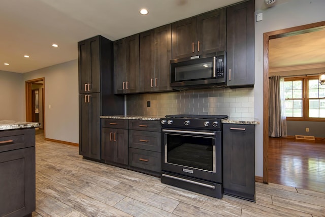 2210 S Catalina Ave, Springfield, MO 65804 - kitchen with black electric range, light wood-style floors, backsplash, recessed lighting, and dark brown cabinetry