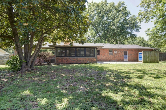 2210 S Catalina Ave, Springfield, MO 65804 - back of property featuring brick siding, a sunroom, and a patio area