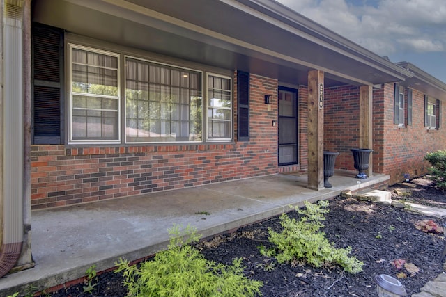 2210 S Catalina Ave, Springfield, MO 65804 - doorway to property featuring covered porch and brick siding