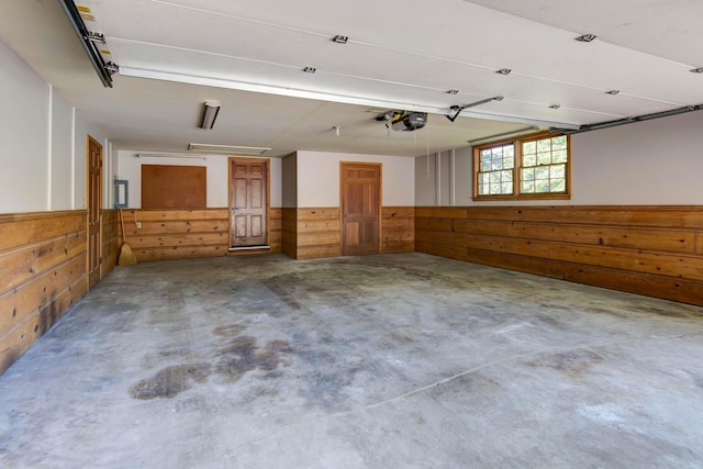 2210 S Catalina Ave, Springfield, MO 65804 - garage with wood walls, wainscoting, and a garage door opener