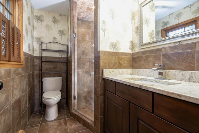 2210 S Catalina Ave, Springfield, MO 65804 - bathroom featuring tile walls, vanity, a shower stall, tile patterned flooring, and wainscoting