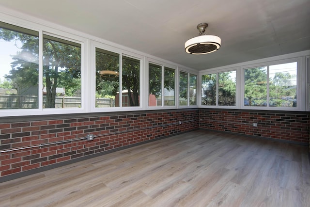 2210 S Catalina Ave, Springfield, MO 65804 - unfurnished sunroom featuring brick wall and wood finished floors