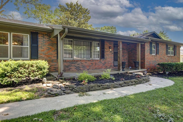 2210 S Catalina Ave, Springfield, MO 65804 - ranch-style home with brick siding, covered porch, and a front lawn