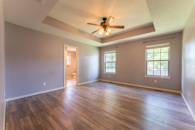 865 E Striper Dr, Nixa, MO 65714 - spare room featuring a tray ceiling, wood finished floors, and ceiling fan
