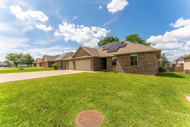 865 E Striper Dr, Nixa, MO 65714 - view of front facade featuring brick siding, concrete driveway, a garage, roof mounted solar panels, and roof with shingles