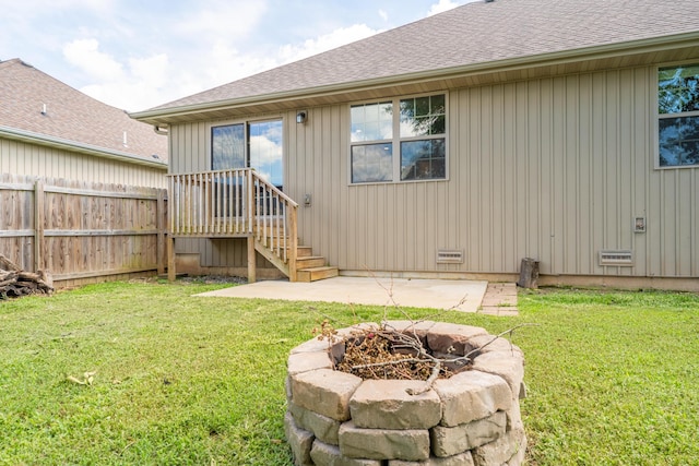 865 E Striper Dr, Nixa, MO 65714 - rear view of house featuring a fire pit, a patio, and a shingled roof