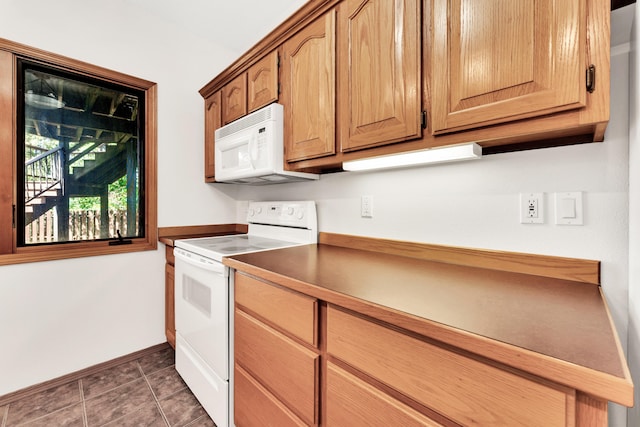 201 Silver Oak Ln, Branson West, MO 65737 - kitchen featuring white appliances, dark tile patterned floors, and dark countertops