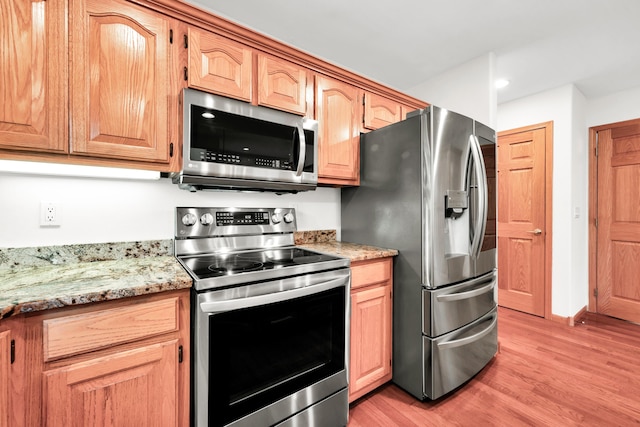 201 Silver Oak Ln, Branson West, MO 65737 - kitchen featuring stainless steel appliances, light wood finished floors, and light stone countertops