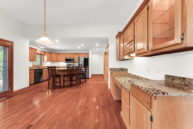 201 Silver Oak Ln, Branson West, MO 65737 - kitchen featuring appliances with stainless steel finishes, a kitchen breakfast bar, wood finished floors, a center island, and recessed lighting