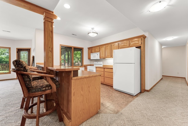 201 Silver Oak Ln, Branson West, MO 65737 - kitchen with white appliances, light carpet, a breakfast bar, a peninsula, and recessed lighting