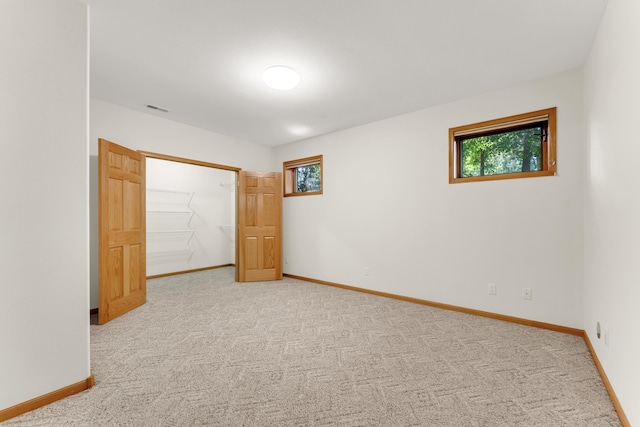 201 Silver Oak Ln, Branson West, MO 65737 - unfurnished bedroom with multiple windows, carpet floors, a walk in closet, and a closet