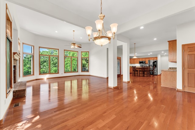 201 Silver Oak Ln, Branson West, MO 65737 - unfurnished living room featuring recessed lighting, ceiling fan, healthy amount of natural light, light wood-type flooring, and a chandelier